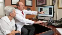 doctor with patient showing scans